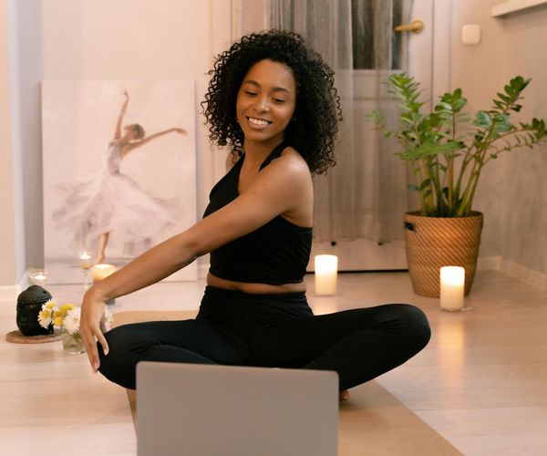 Person stretching gently indoors, showing improved flexibility and calmness.